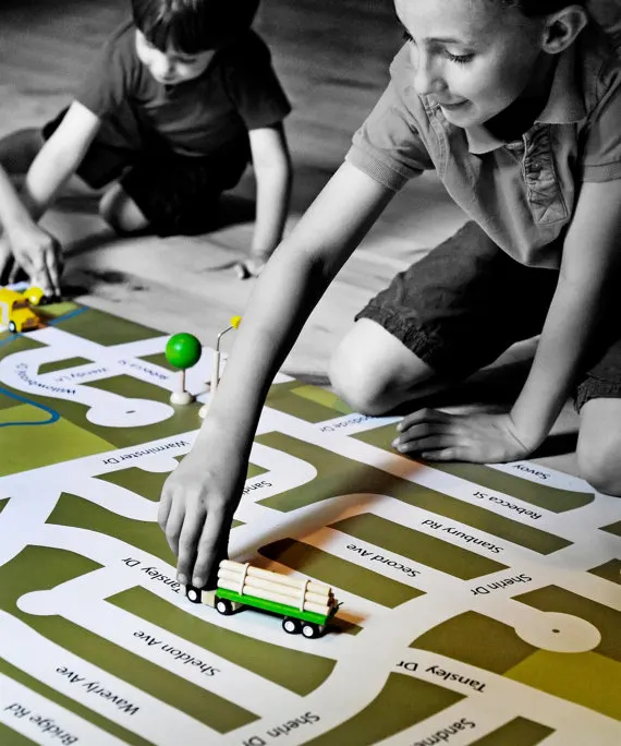 Giant neighborhood play mats that will help kids get familiar with their local streets while riding their toy cars on these custom-designed road maps - at Non Toy Gifts