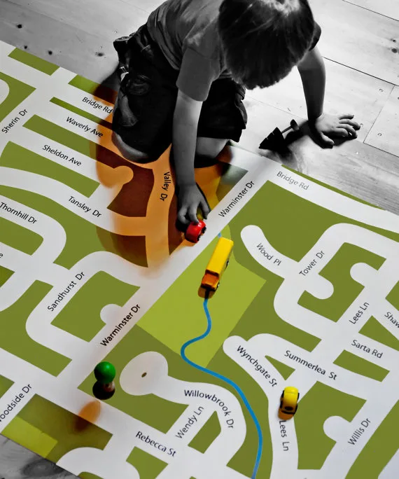 Giant neighborhood play mats that will help kids get familiar with their local streets while riding their toy cars on these custom-designed road maps - at Non Toy Gifts
