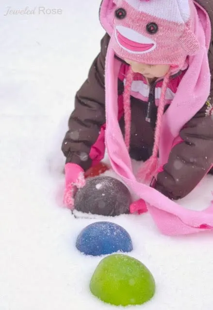 Make giant colored ice marbles - one of the 20 outdoor snow activities for kids. Be prepared for that snowy day when school is off and kids want to go outside and play. This list of snow and ice activities for kids of all ages is just what you need for any winter day. | at Non Toy Gifts