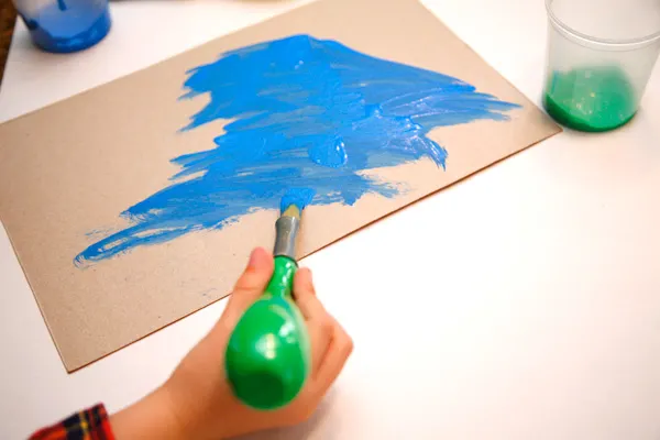 Painting the cereal box in order to use it for a spring craft. We made twig and cereal flowers. | at Non Toy Gifts