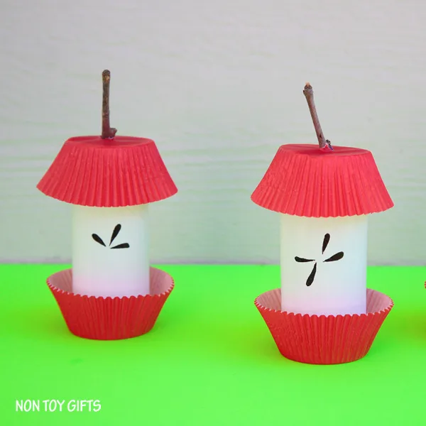 Paper roll, cupcake liners and sticks to make a paper roll apple craft for kids