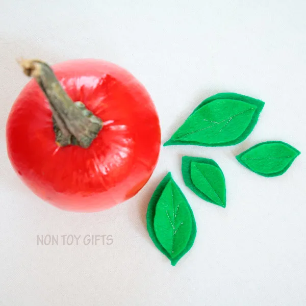 Easy apple pumpkin craft for kids. Perfect fall craft for toddlers or older kids. Paint small pumpkins red and glue a few green leaves. | at Non Toy Gifts