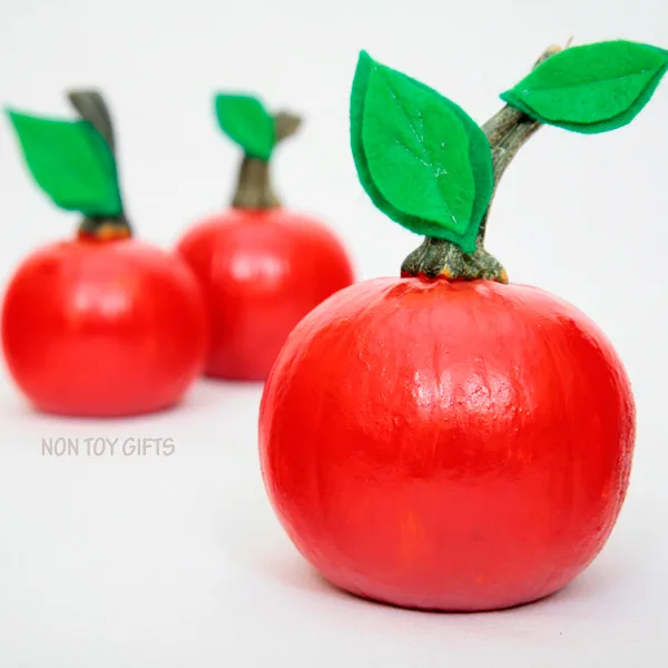 Easy apple pumpkin craft for kids. Perfect fall craft for toddlers or older kids. Paint small pumpkins red and glue a few green leaves. | at Non Toy Gifts