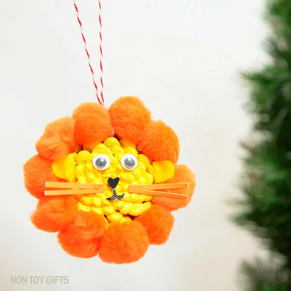 DIY pine cone lion ornament. Fun winter craft for kids. | at Non-Toy Gifts