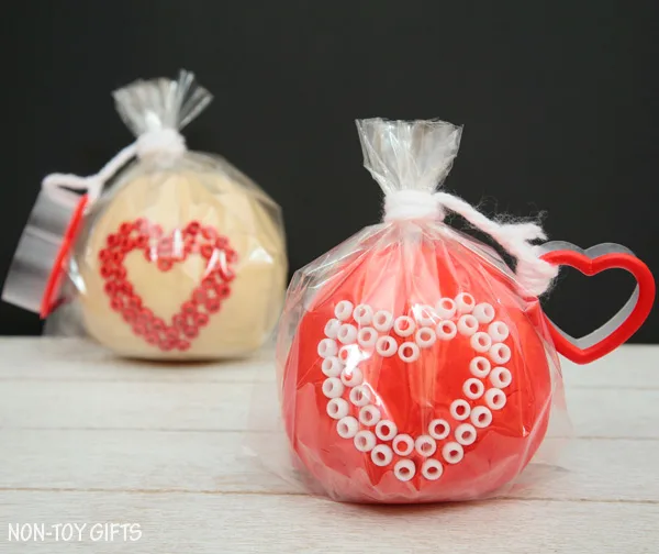These play dough Valentines make great Valentine non-candy treats for preschool and kindergartner classroom party. Fun Valentine's Day activity for kids. Use heart shaped cookie cutter and decorate with beads | at Non-Toy Gifts