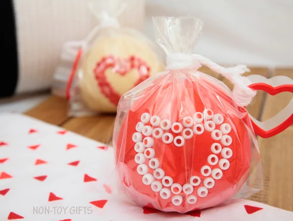 These play dough Valentines make great Valentine non-candy treats for preschool and kindergartner classroom party. Fun Valentine's Day activity for kids. Use heart shaped cookie cutter and decorate with beads | at Non-Toy Gifts