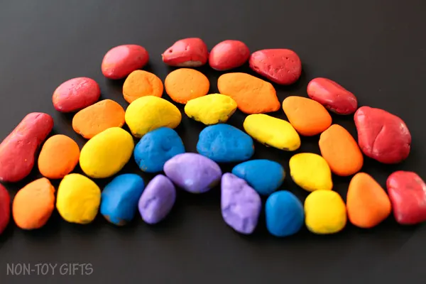 Painted stone rainbow craft for kids. Celebrate spring with a fun and easy craft for toddlers and older kids. | at Non-Toy Gifts