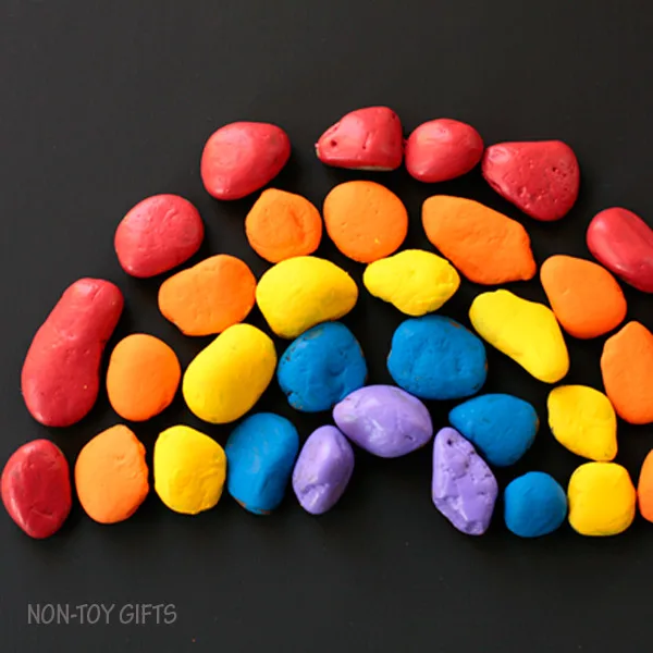 Painted stone rainbow craft for kids. Celebrate spring with a fun and easy craft for toddlers and older kids. | at Non-Toy Gifts