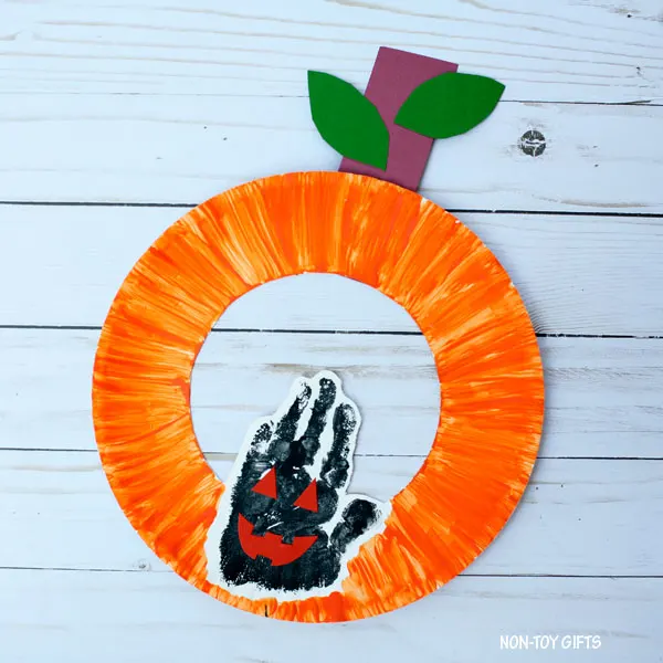 Halloween craft for kids - paper plate and handprint pumpkin