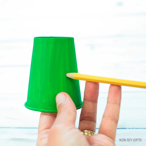 Make a hole in the paper cup