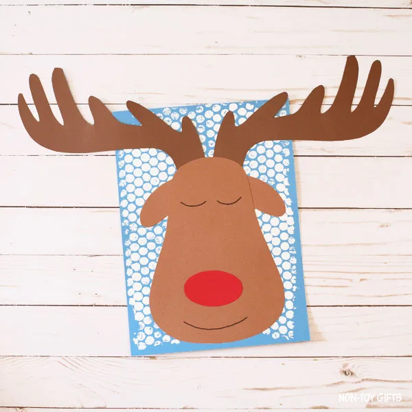 Sleeping reindeer on blue paper