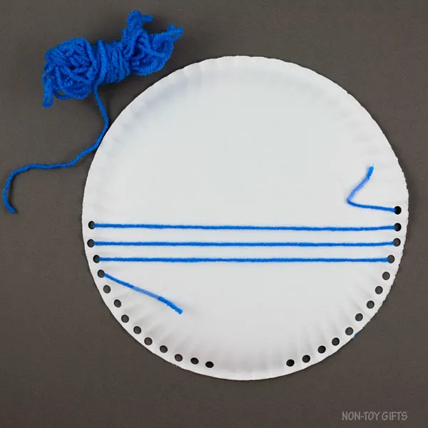 Yarn secured at the back of paper plate