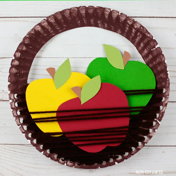 Easy paper plate and yarn apple basket craft for kids