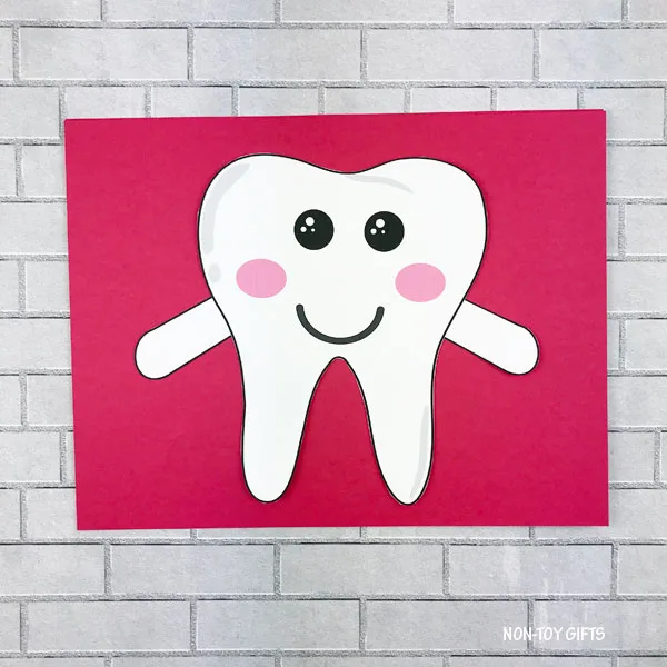 Tooth with arms on colored paper