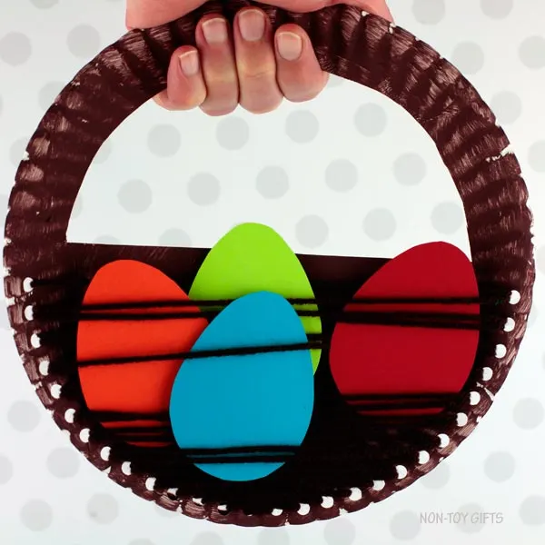 Holding Paper plate Easter basket craft