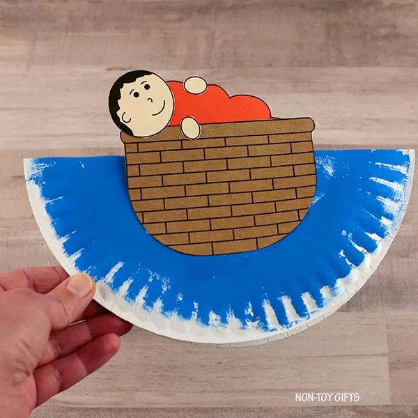 glue baby Moses onto the paper plate