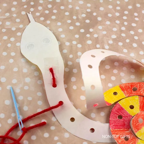 tape yarn to the back of the snake