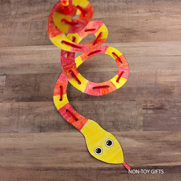 spiral paper and yarn snake craft printable for kids to make for the Year of the Snake