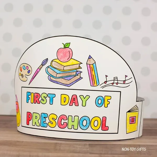 Printable back-to-school hat craft for preschoolers with backpack, books, and apple illustrations