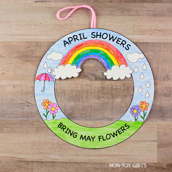 April Showers Bring May Flowers wreath craft printable with rainbow, clouds, raindrops, and flowers, perfect spring classroom activity for kids