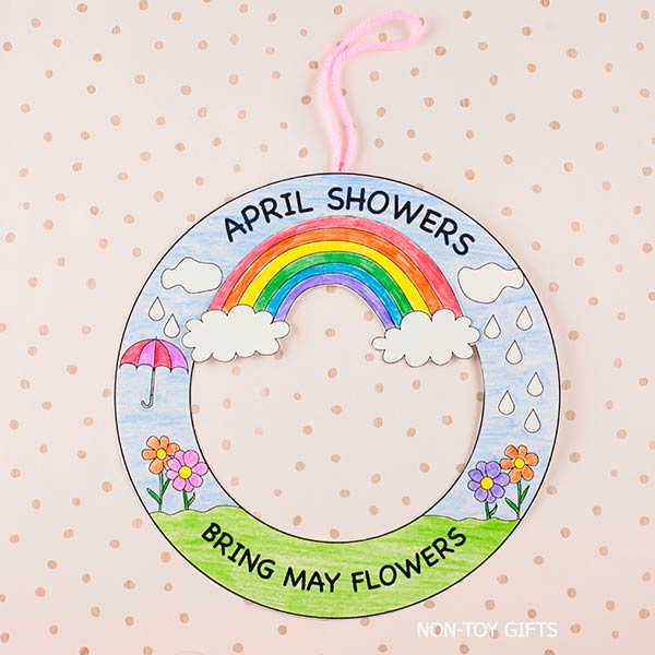 spring wreath craft printable for kids with rainbow clouds raindrops and flowers, April showers bring May flowers activity for preschool and kindergarten